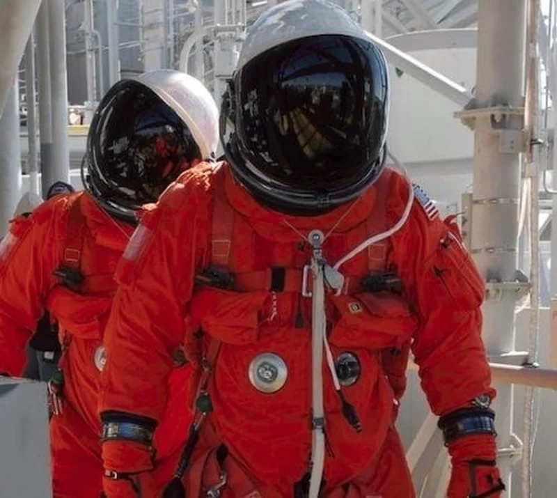 NASA astronaut with early space blanket technology, 1964